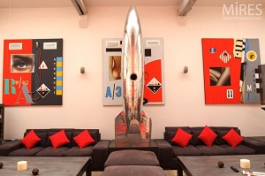 metal spaceship sculpture and red and black wall art in paris loft design